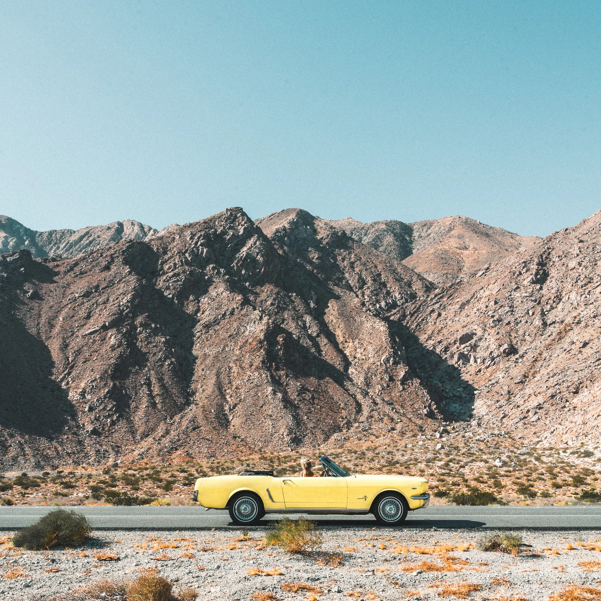 vintage-yellow-mustang-road-trip-in-the-desert-to-palm-springs.jpg